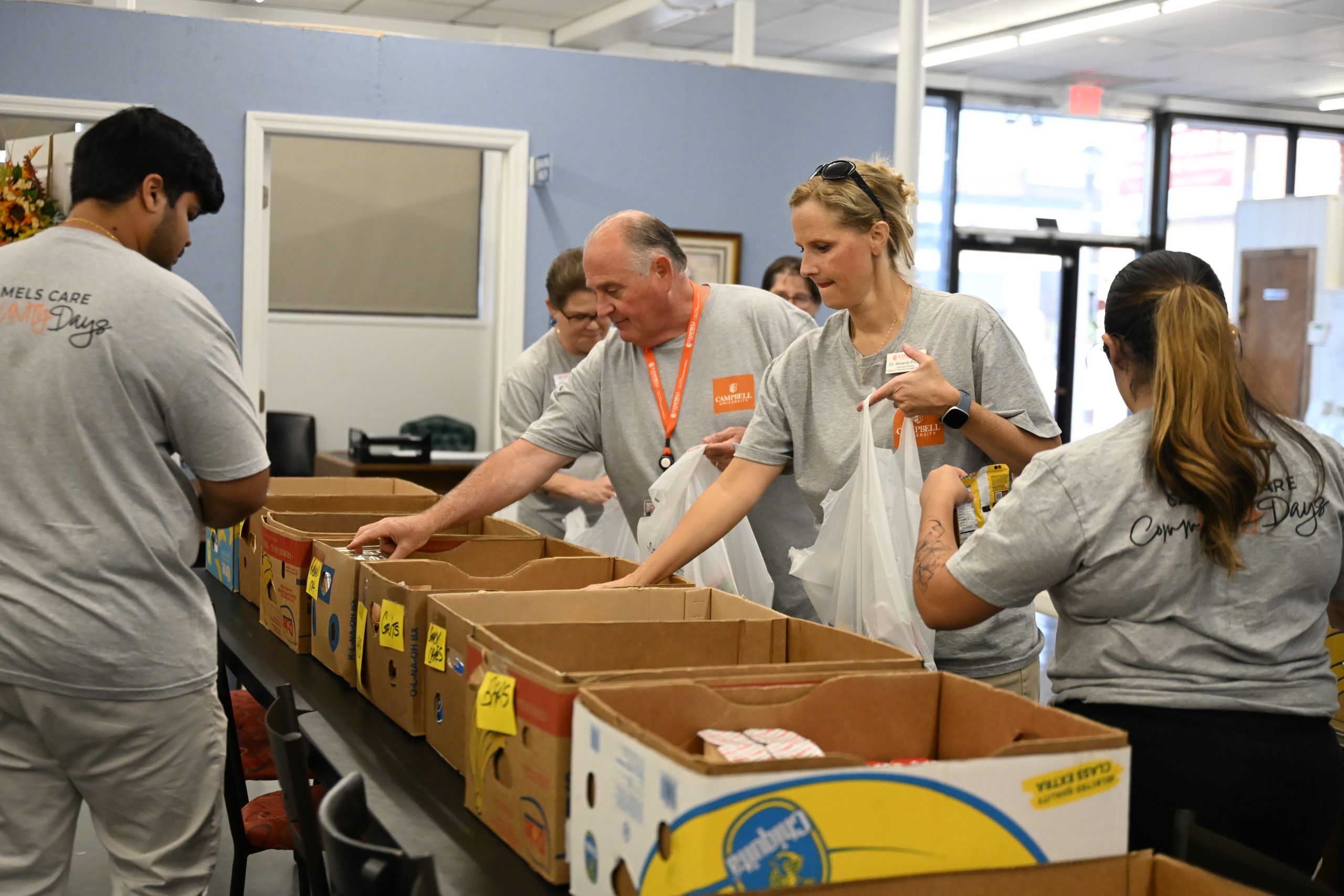 People packing food into bags.