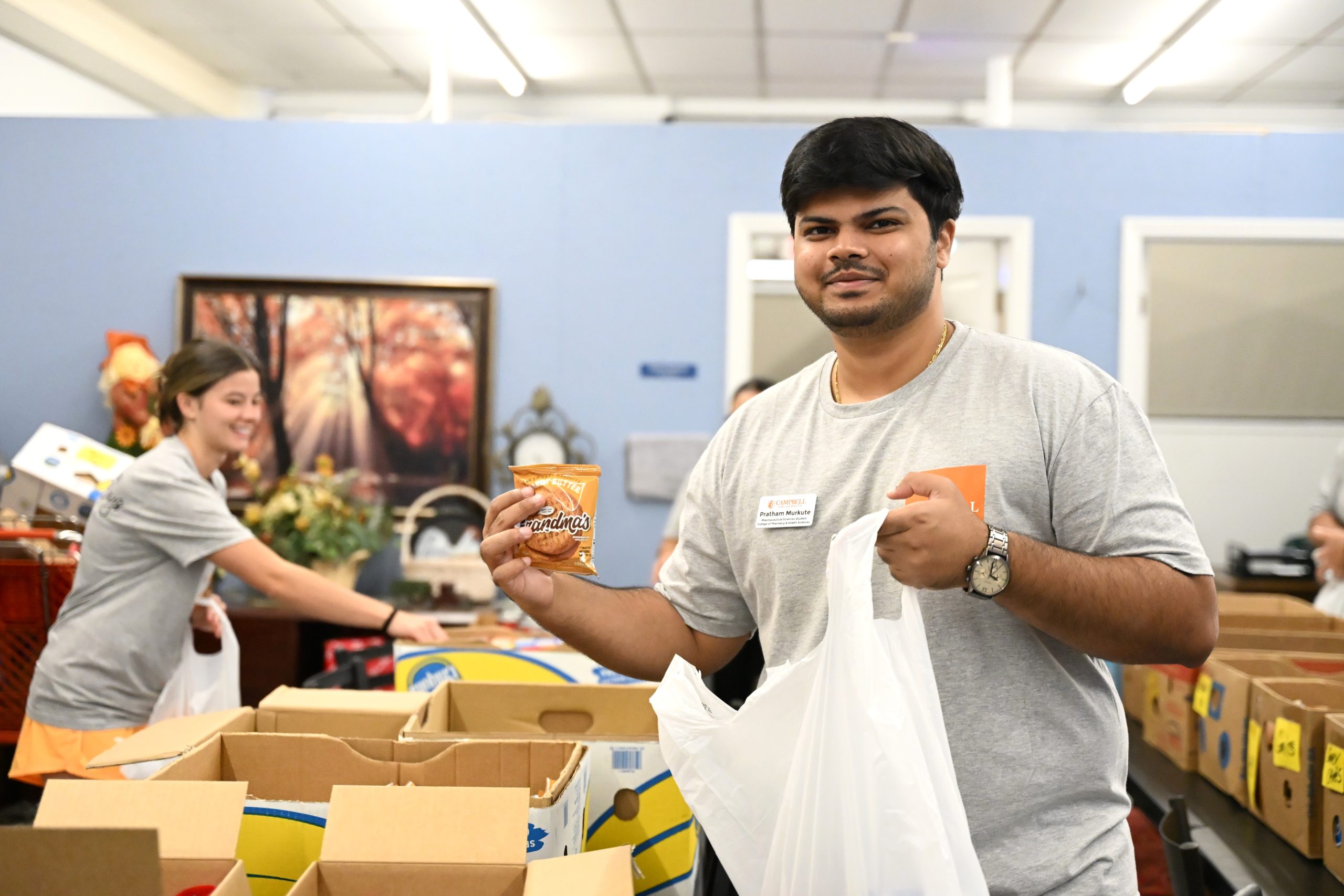 Student putting food into a bag