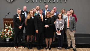 Distinguished Alumnus Stan Cole '87 poses for a photo with his family and friends