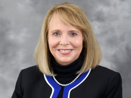 Female in black suit with blue and white trim