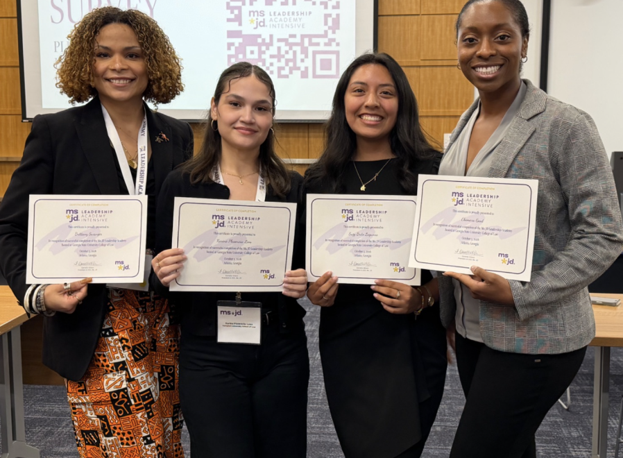 Photo of Brittany Swanger ‘27, Suzy Brito Lagunas ‘27 and Karina Plasencia-Leos ‘28 and Chimara Good '28 holding certificates from Ms. JD
