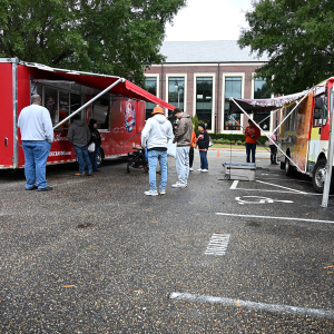 Guests order food from trucks parked outside the Cornelia Campbell Alumni House during the 2026 Alumni Block Party.
