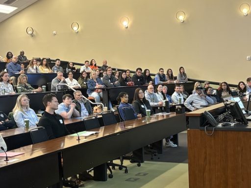 Med school Dean Dr. David Tolentino speaks to a group of students.