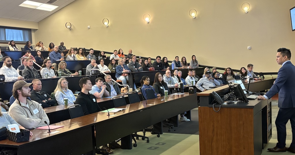 Med school Dean Dr. David Tolentino speaks to a group of students.