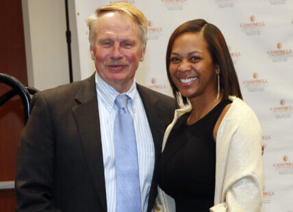 Photo of Dean Leonard posing with an award winner at Family Day Law Banquet