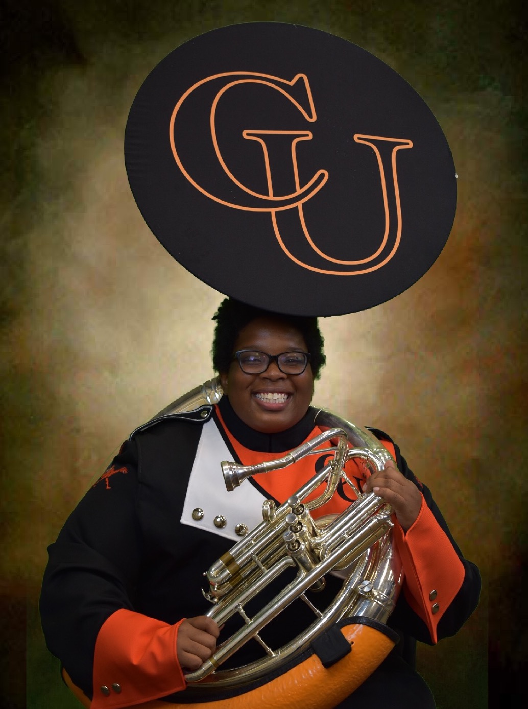 Aislinn Ramos holding a Sousaphone with CU on it.