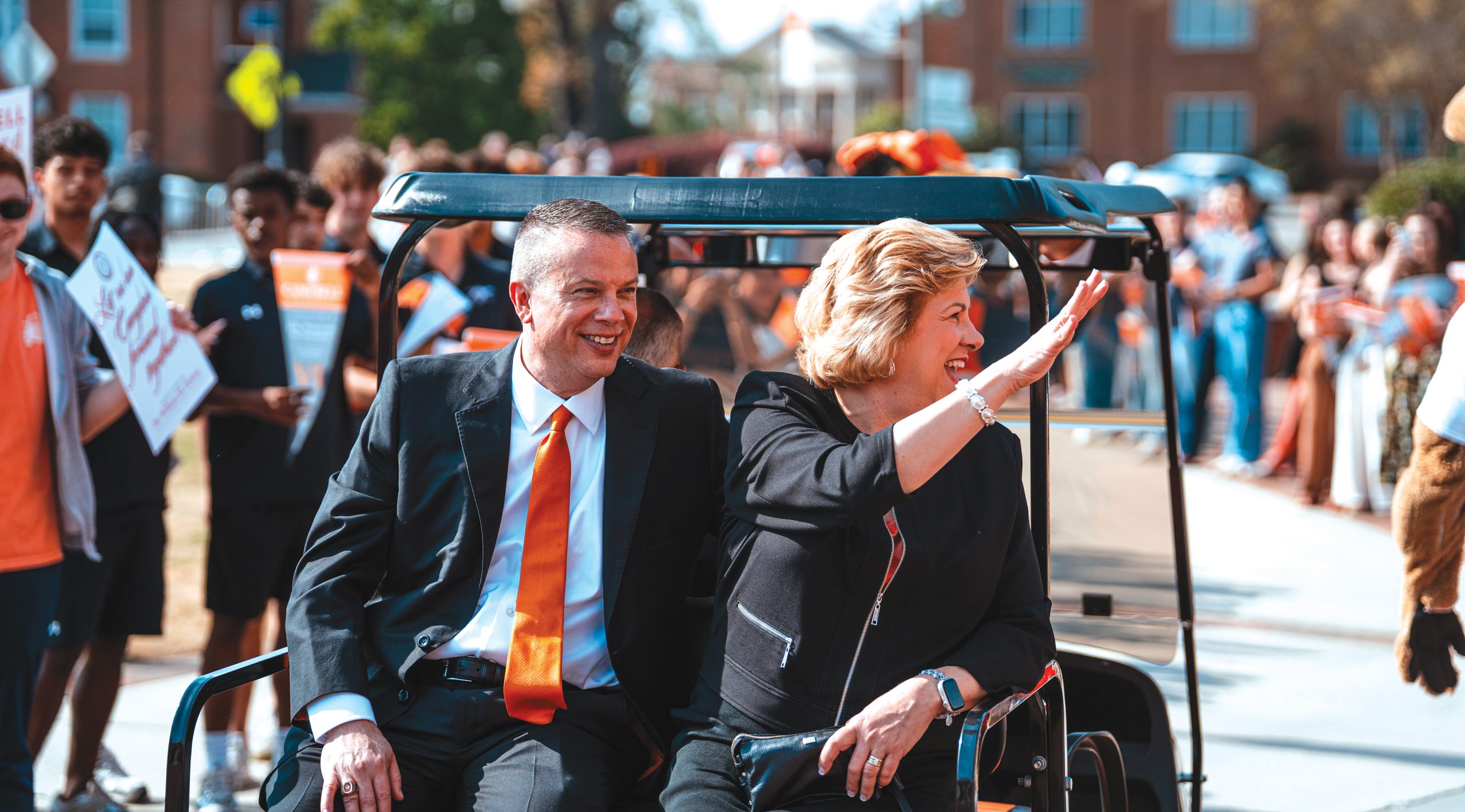 President Downs and Kimberly Downs wave to students following his investiture ceremony in March.