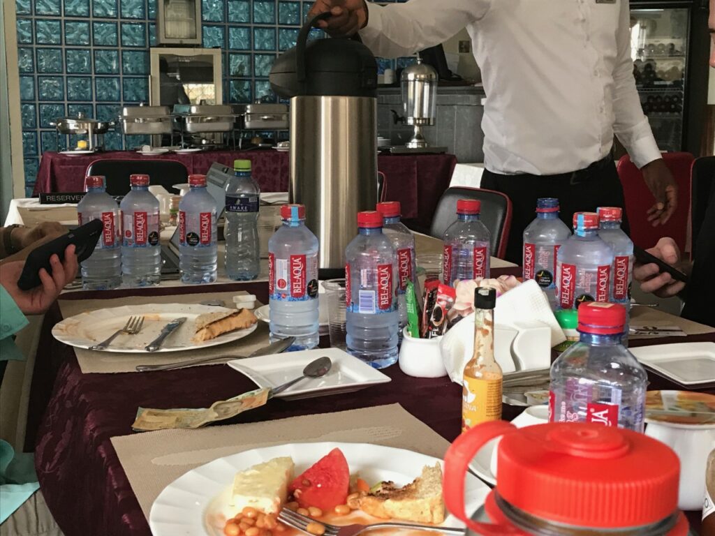 Photo showing a dining table with typical Ghananian breakfast remnants including an omelet, baked beans and white bread