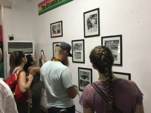 Photo of Campbell Law students looking at photos on a museum wall in Ghana