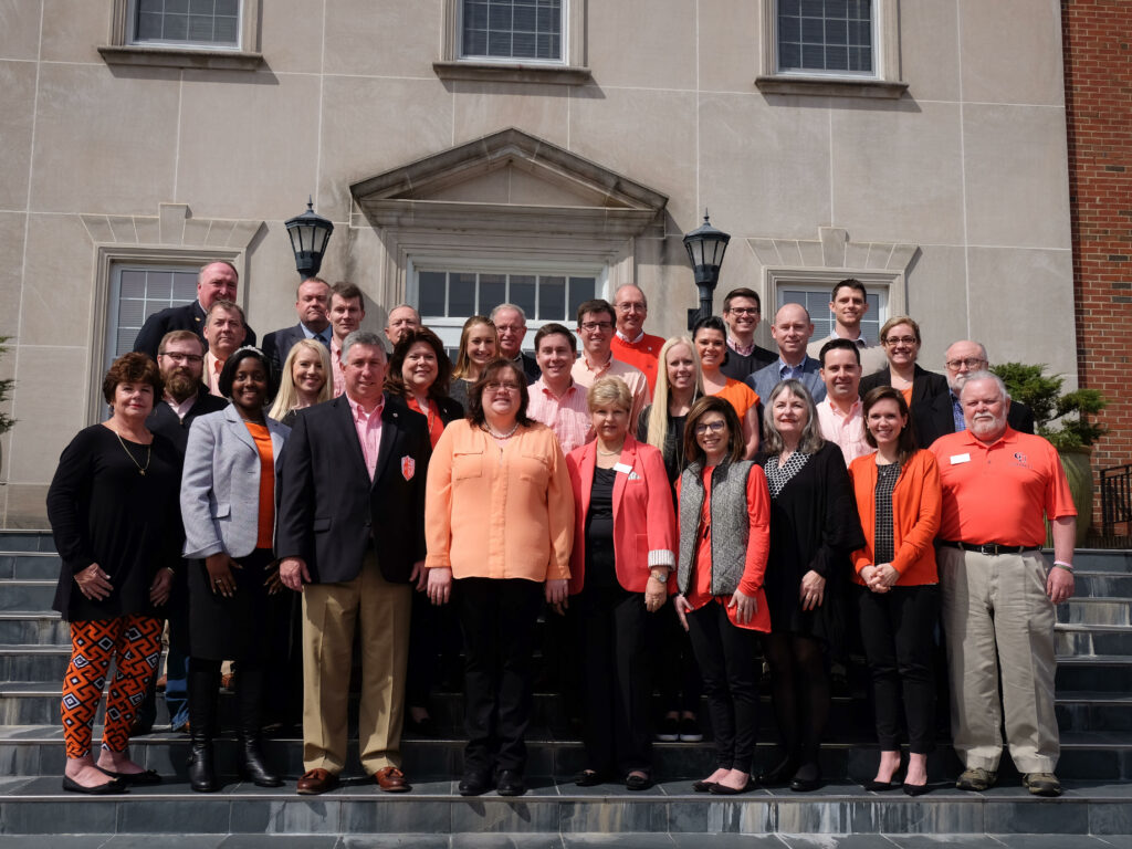 Photo of the Alumni Board of Directors standing on the steps of Taylor Hall.