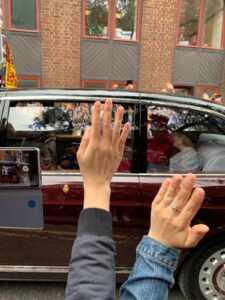 Photo of Queen Elizabeth inside a passing car with hands waving