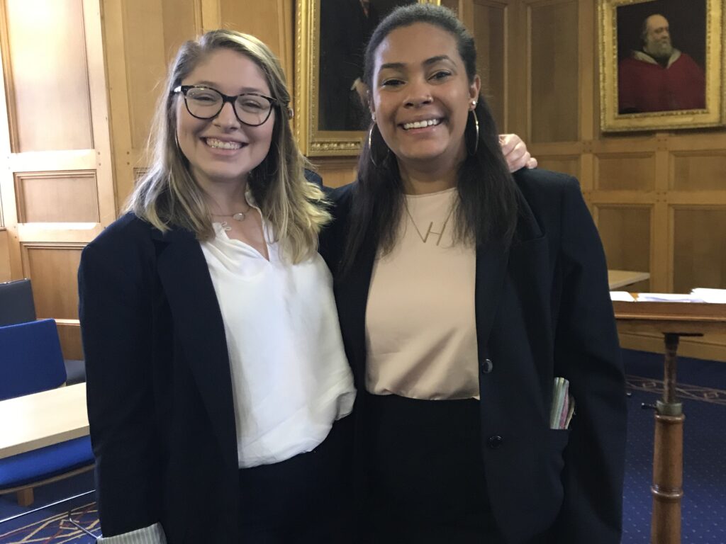 Photo of Chamberlain Collier '20 posing in a Scottish courtroom with her friend Halee Morris '20