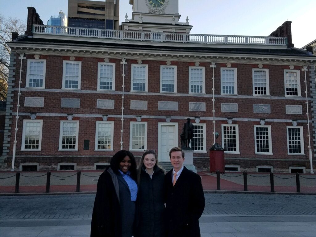 Photo of three Campbell Law advocates standing in front of Constitution Hall in Philadelphia