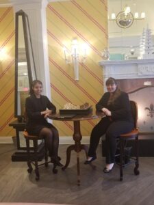 Photo of two law students posing in chairs