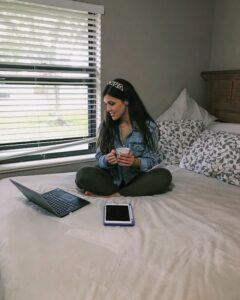 female student studying on her bed