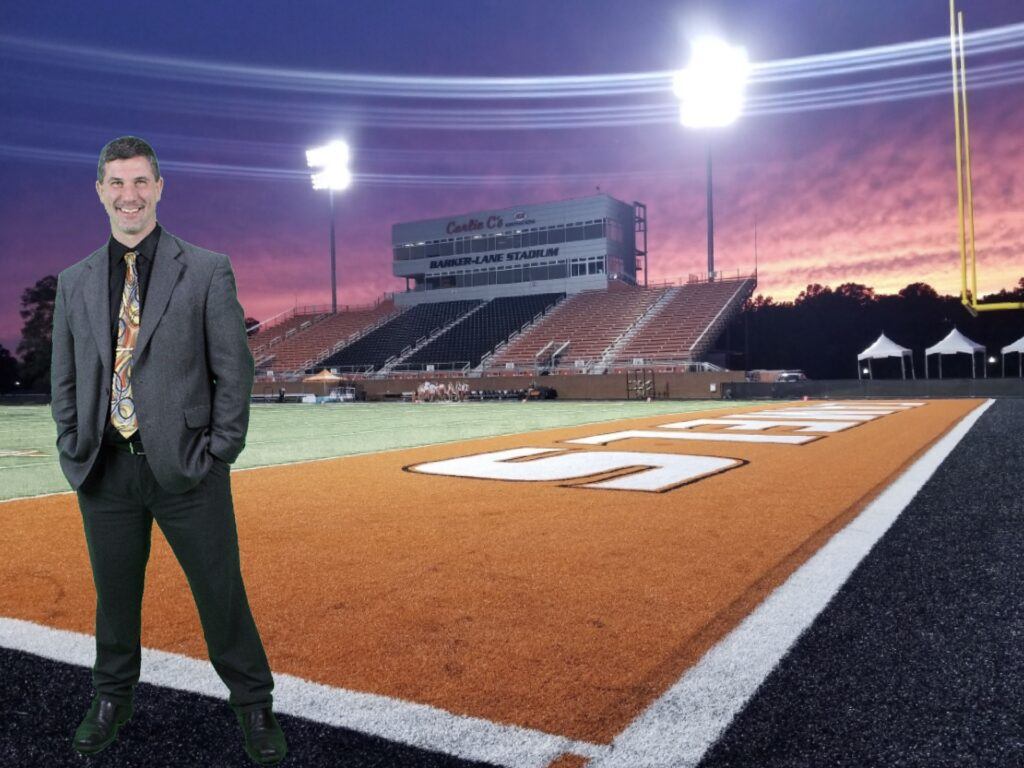 Dr. Phillips standing on the Football field with a sunset.