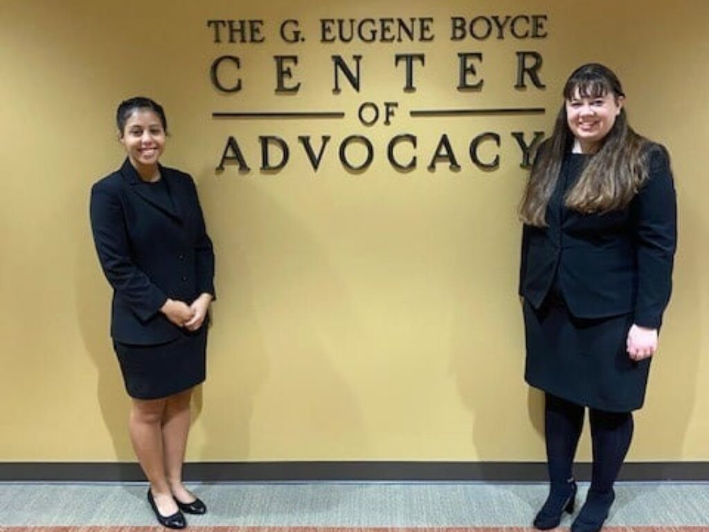 Photo of Campbell Law Advocates posing in front of Gene Boyce Center for Advocacy sign