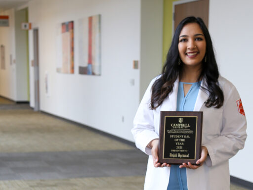 student holding award