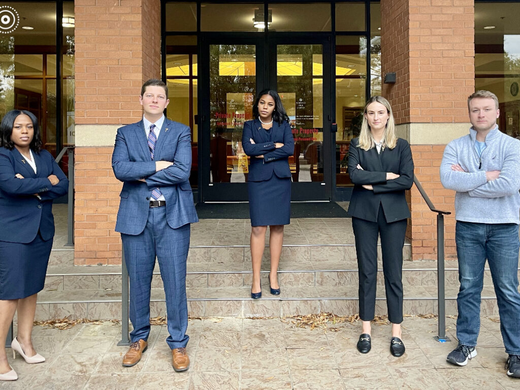 Photo of law school student mock trial competitors posing in front of the law school