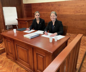 Photo of members of Campbell Law Belgrade Moot Court team in court preparing