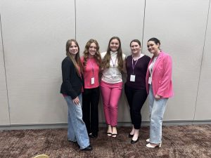 Emma Guild (4th from right) posing for photo with peers 