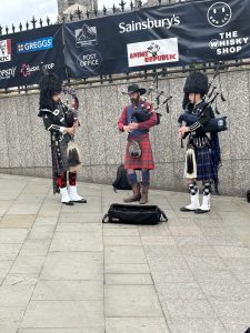 Photo of bagpipers playing on the street in Scotland