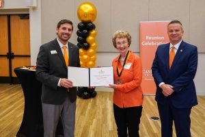 Golden Club member Anne Quakenbush poses with her induction certificate with Grant Harden and Dr. William M. Downs