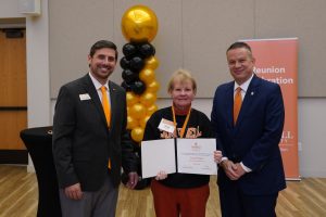 Golden Club member Tonia Pridgen poses with her induction certificate with Grant Harden and Dr. William M. Downs