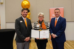 Golden Club member Cecilia Gregory poses with her induction certificate with Grant Harden and Dr. William M. Downs