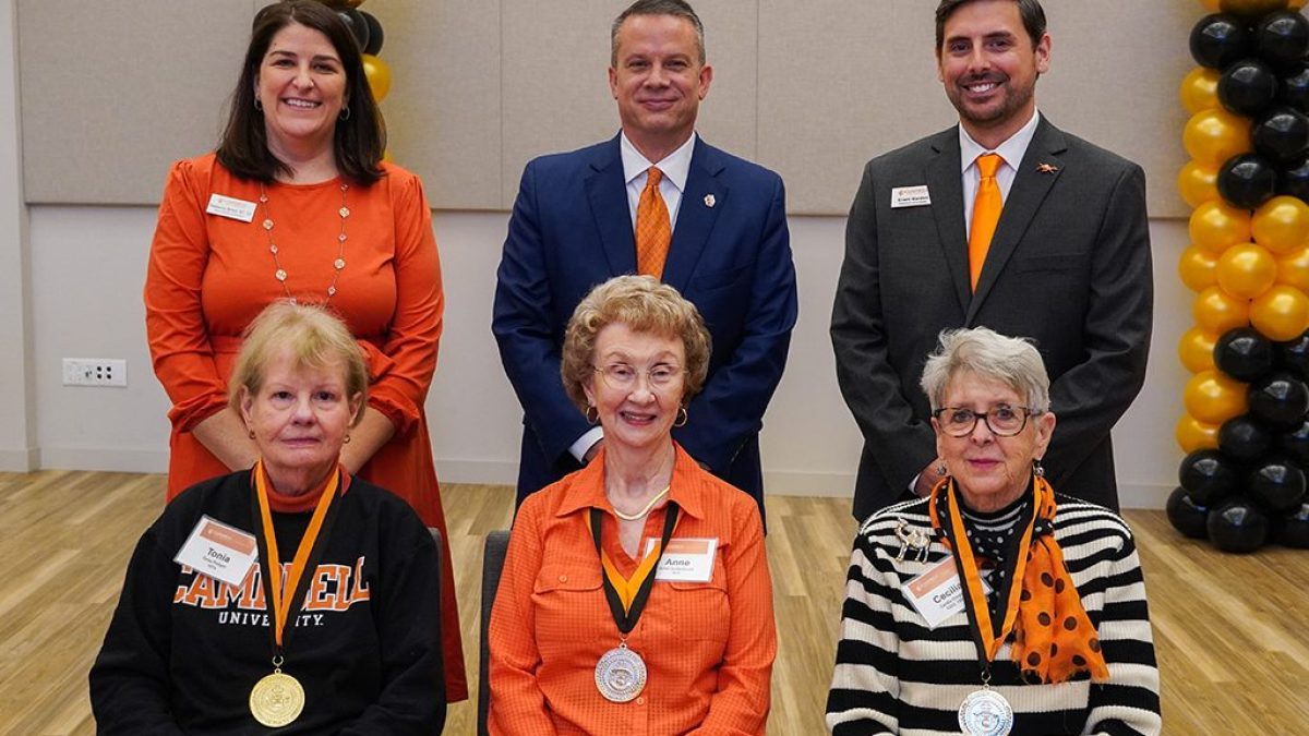 Three Golden Club inductees seated in a row with Alumni Board president Rebecca Brock, Campbell president Dr. William M. Downs and Director of Planned Giving Grant Harden standing behind
