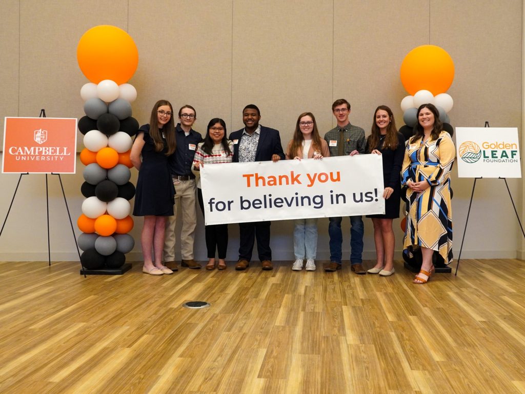 Golden Leaf scholars posing with a sign that reads 