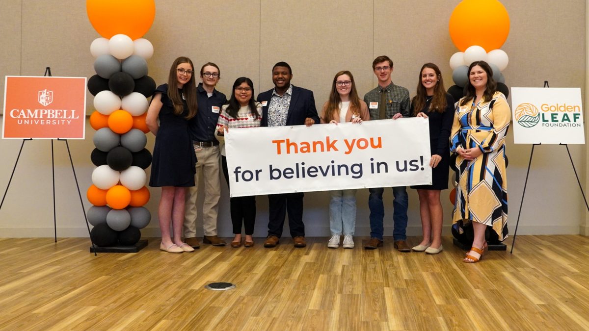 Golden Leaf scholars posing with a sign that reads 