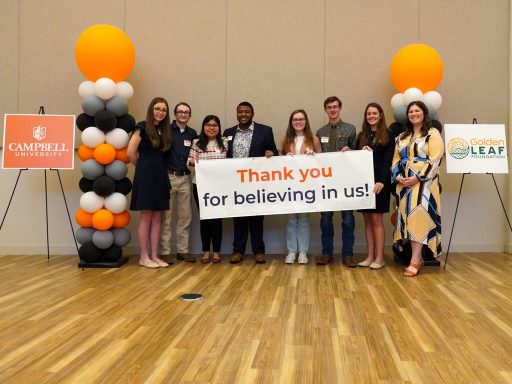 Golden Leaf scholars posing with a sign that reads 