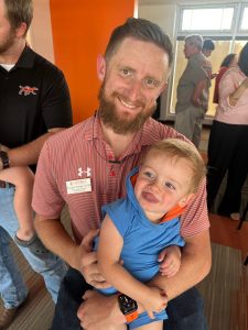 Morgan Timiney holding his son.