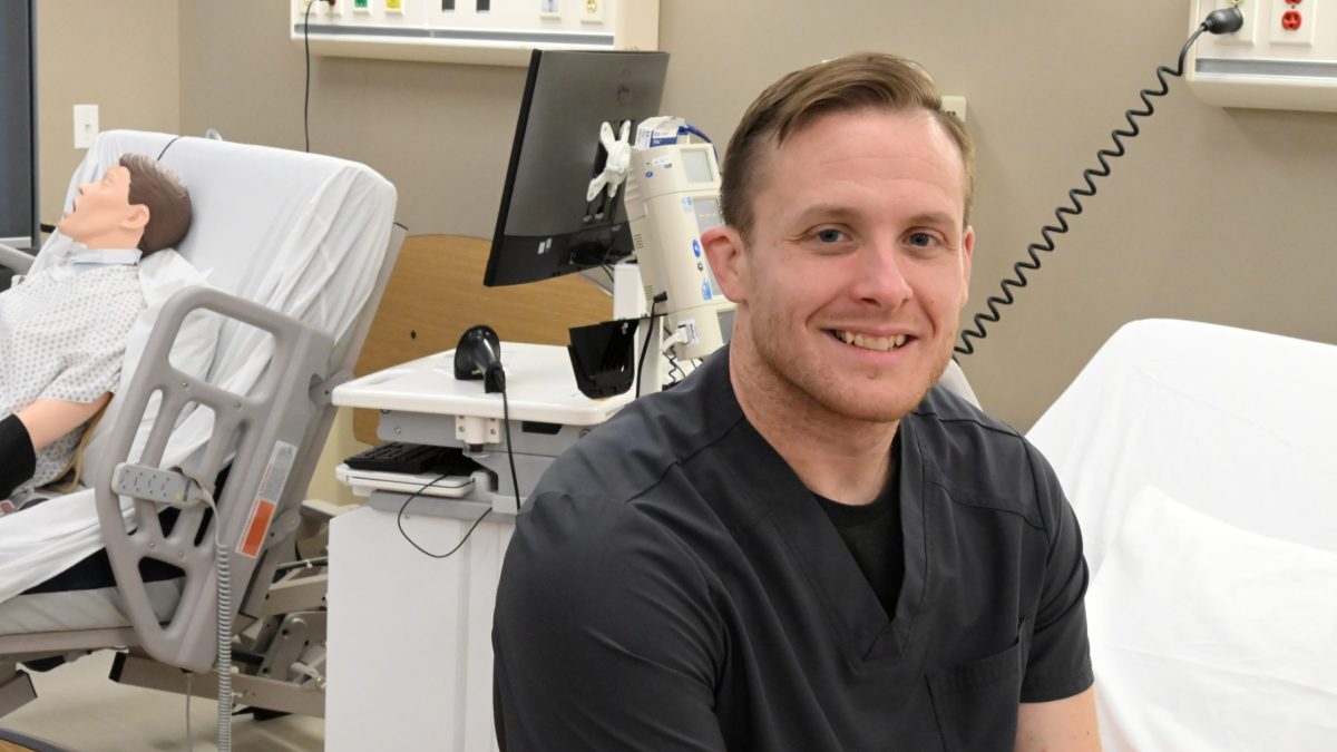 Christopher Donovan sitting in nursing lab