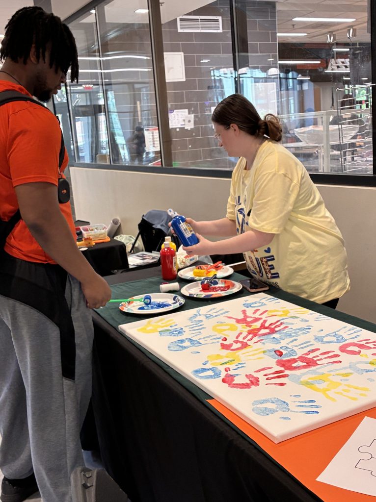 student signing up at table in Union