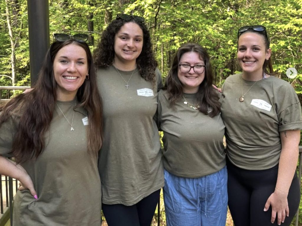 Photo of four Campbell Law female student members of LSAS posing at the Walk in Their Shoes event
