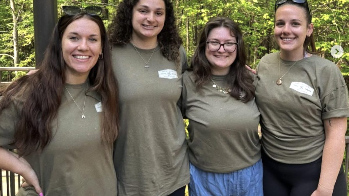 Photo of four Campbell Law female student members of LSAS posing at the Walk in Their Shoes event