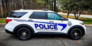 A Chesterfield County Police SUV marked “Human Trafficking Awareness” is parked beside a wooded area.