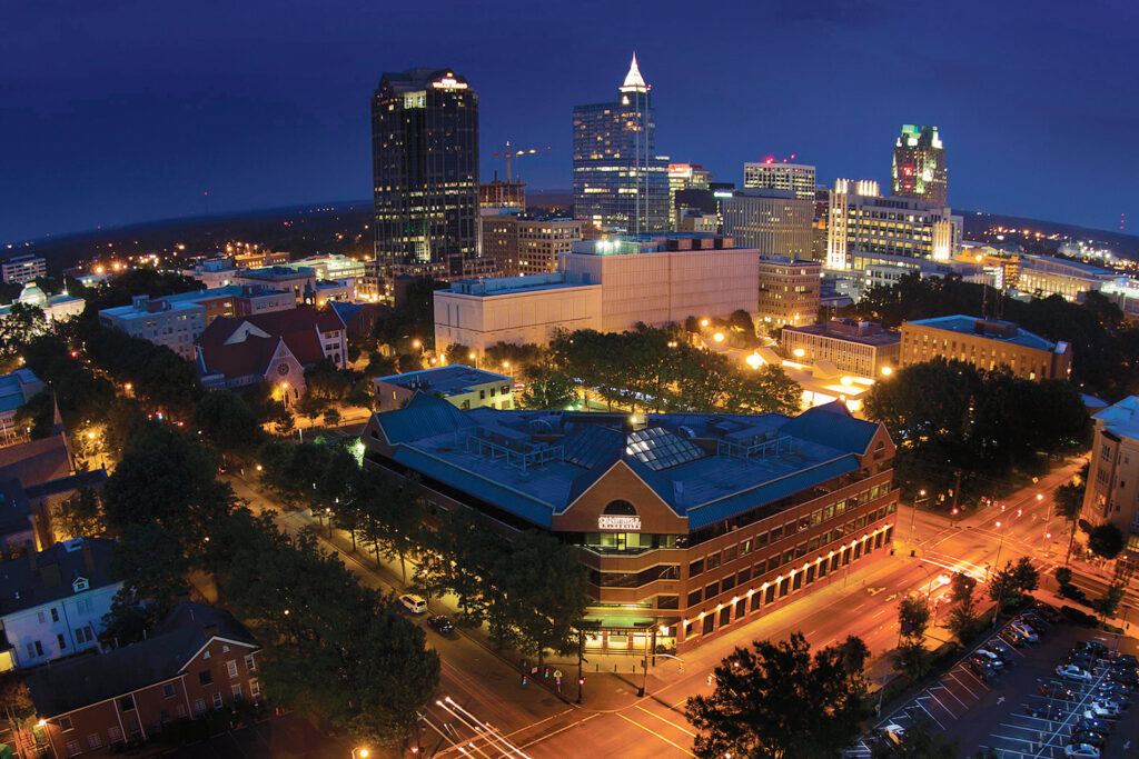 image of law school and downtown raleigh at night