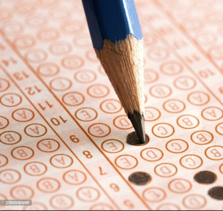 Photo of a test with bubbles and a pencil shading in one of the bubble answers