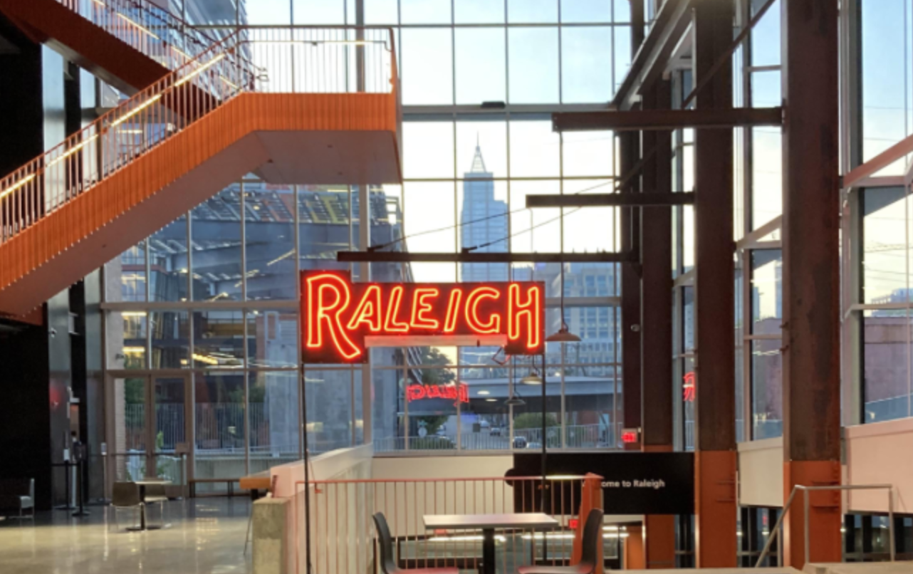 Photo of neon Raleigh sign lit up inside Union Station