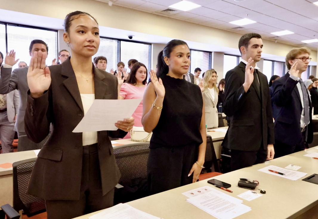 Photo of four Campbell Law incoming students from the Class of 2029 taking the professional oath during Orientation 2026